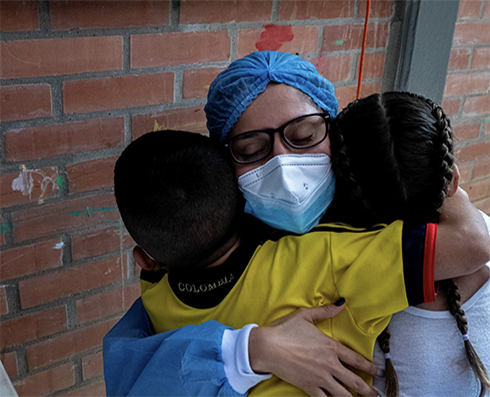 female nurse hugging children